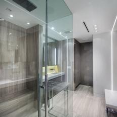 Contemporary Gray Tile Bathroom With a Glass Enclosed Shower