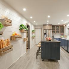 Recessed Lighting Illuminates Kitchen With Blue Cabinets and Hanging Wood Baskets