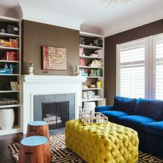 Royal Blue Sofa and Yellow Tufted Coffee Table Under Gold Spiked Light Fixture in Contemporary Living Room 