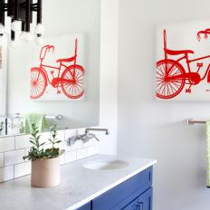 Kids Bathroom With Frameless Mirror and Bicycle Art