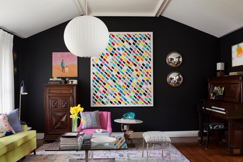 Eclectic Black Living Room With Colorful Art and Furniture