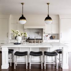 Marble Kitchen Island with Symetrical Black and White Pendant Lights