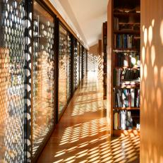 Metal Cutout Sunshades Allow Dappled Light Into Second Floor Library