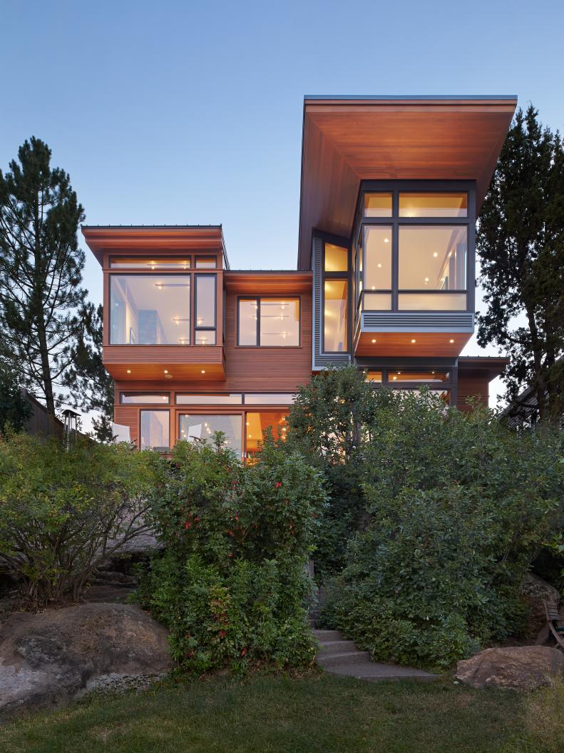 Contemporary Exterior With Brown Wood Siding and Green Bushes