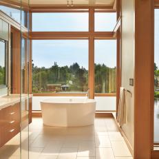 Relaxing Bathroom With Soaking Tub and River View