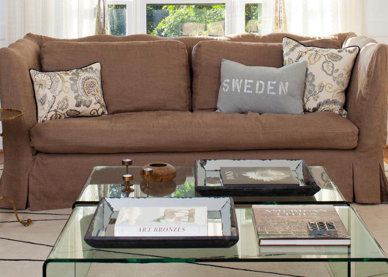 Chic Living Space with Glass Coffee Table and Word Throw Pillows