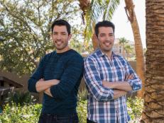 Hosts Drew and Jonathan Scott pose in the back yard of their home, as seen on Brother vs. Brother. (portrait)