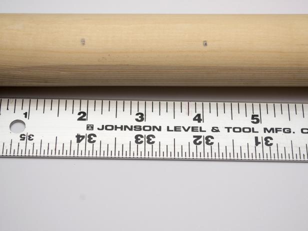 Mark two holes at each end of the dowel, at 2” and 4”.