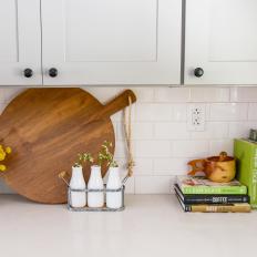Bright Recipe Books and Wooden Kitchen Utensils Add Color to Neutral Farmhouse Kitchen 
