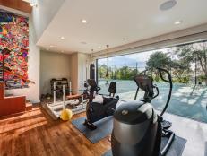 Gym with Multi-Glass Sliding Door Opening Onto Tennis Courts 