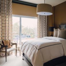 Brown Bedroom With Drum Pendant Light and Rustic Bed