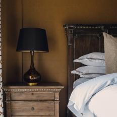 Rustic Nightstand and Bed in Brown Bedroom
