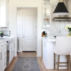 White Open Plan Kitchen With Gray Rug