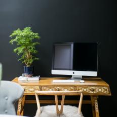 Wood Desk Against Black Wall