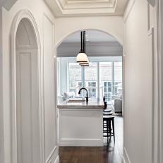 Classic, Traditional Hallway With Arched Doorways, Circular Light Fixture and Hardwood Floor 