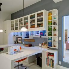 Transitional Sewing and Crafts Room With Color Coordinated Fabric Shelves, Glass Door Cabinets and Adjustable Table Panels