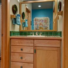 Small Bathroom Vanity With Woodgrain Drawers, Green Tile Countertop Border and Wood Framework 