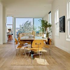 White Open Plan Dining Room With Yellow Chairs