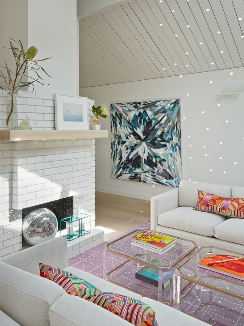 Contemporary Living Area With White Brick Fireplace & Colorful Accents