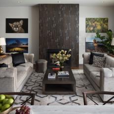 Transitional Living Room With Neutral Tufted Sofas and Nature Photos