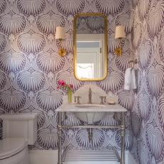 Toilet and Antique-Style Sink With Bold Patterned Wallpaper