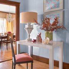 Eclectic Hall With Seashell Decor and Floral Artwork
