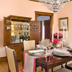 Peach-Hued Traditional Dining Room With Elegant Chandelier 