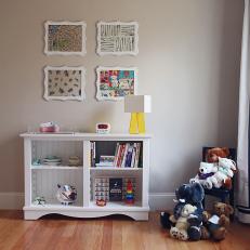 Nursery With White Bookshelf, Wall Art and Stuffed Animals