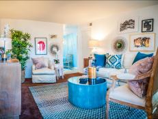 Colorful Eclectic Living Room with Blue Furniture and Pillows and Wall Art