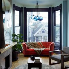Living Room With Bay Window and Orange Velvet Sofa