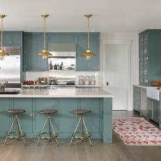 Blue and White Transitional Kitchen With Gold Pendants