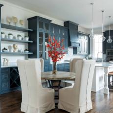 Blue and White Eat-In Kitchen With White Chairs