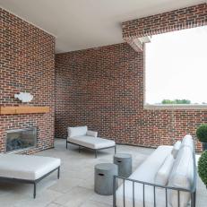 Red Brick Roof Terrace With White Chaises