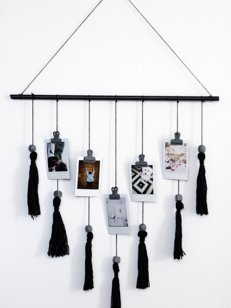 Black Wall Hanging With Tassels and Pictures