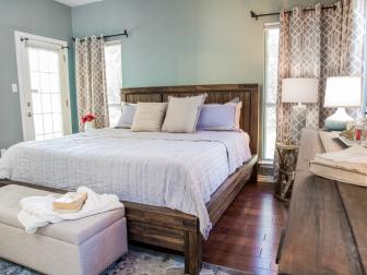As seen on House Hunters Renovation, this renovated Austin, Texas bedroom has a
sleek modern design with gray and blue accents. It features a lamp, curtain panels, storage ottoman, bed, dresser, area rug, pillow shams, coverlet, duvet cover and cable knit throw from Macy's. (After)