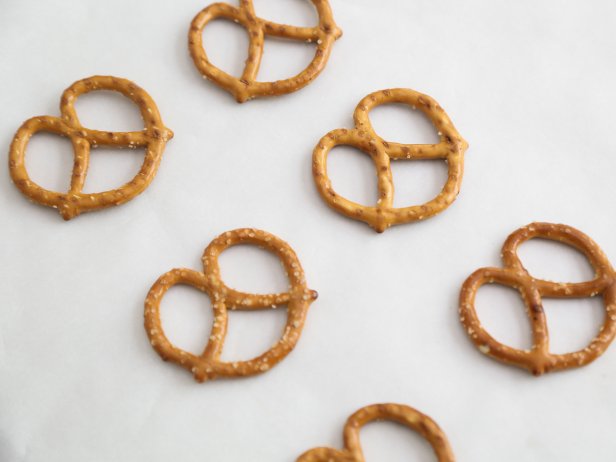 Line the pretzels in rows on a large baking sheet covered with parchment paper.