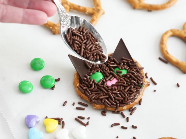 Spoon chocolate sprinkles over the pretzels and let stand until the chocolate firms, about 1 hour. You may also speed the chocolate’s setting by placing the baking sheet in the refrigerator for about 15 minutes.