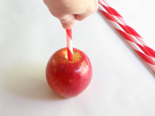 Remove the apple stems and press the sticks into the apples so that the stand upright. Pick up the apples to make sure they are stable and won’t slide off of the stick.