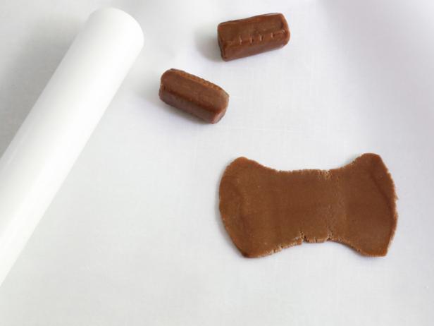 Knead the chocolate chews until they are soft and flexible. Roll them flat with a rolling pin.