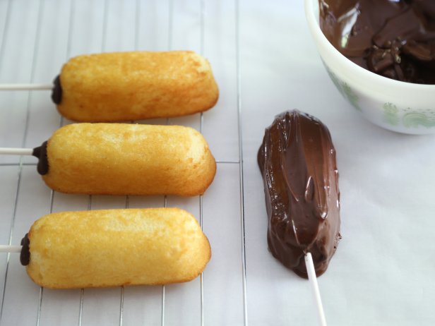 Dip the snack cakes into the chocolate until completely coated. Transfer the cakes to the baking sheet and chill until set, 10 to 15 minutes.