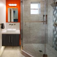 Bright Red Accent Wall in Modern Bathroom With Glass Door Shower and Floating Vanity 