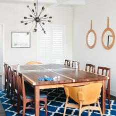 Large Dining Table That Converts to Ping-Pong Table in Family Dining Room With Blue Area Rug 