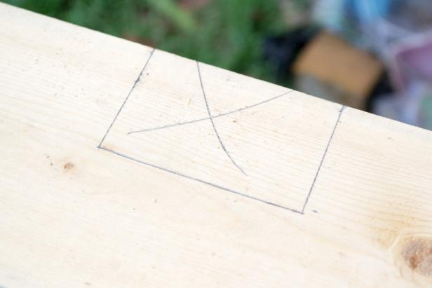 Use a straightedge to connect the tops of the parallel 2 ½ inch lines. This marks the cutout for the rear roof support.