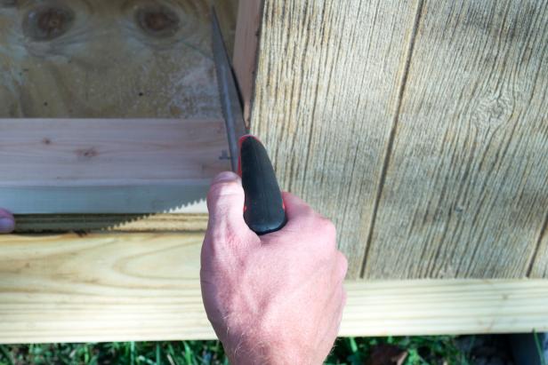Cut out the bottom part of the door frame with a handsaw.