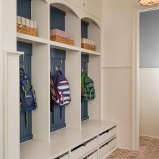 Traditional Mudroom With Blue Cubby Storage, Brick Floor and Upper and Lower Storage Cabinets 