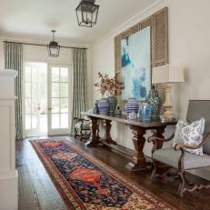 White French Door Access to Traditional Foyer With Gray Upholstered Chairs, Patterned Carpet Runner and Lantern Pendant Lights
