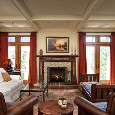 Craftsman Living Room With Rich, Warm Tone Details, White Sofa, Brown Leather Chairs and Decorative Fireplace Surround 