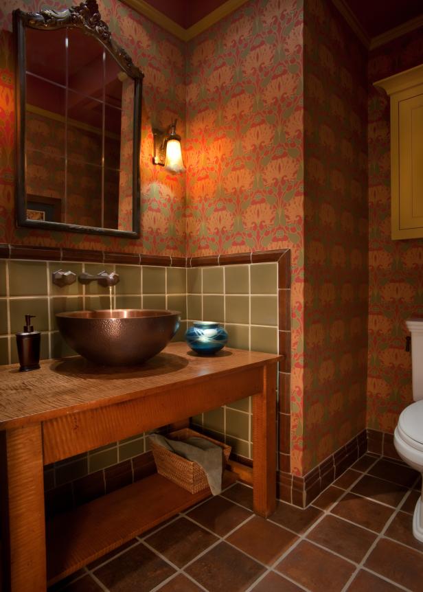 Warm, Low Lit Bathroom With Red Wallpaper and Green Tile Backsplash