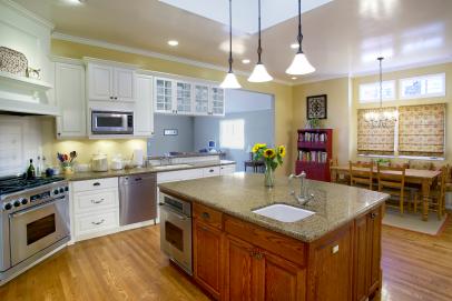 Yellow Walls And White Cabinets In Traditional Kitchen With Wood