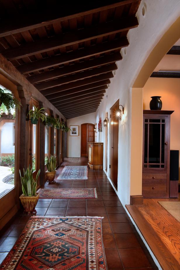 Mediterranean Hall With Dark Wood Beam Ceiling & Brown Tile Floor